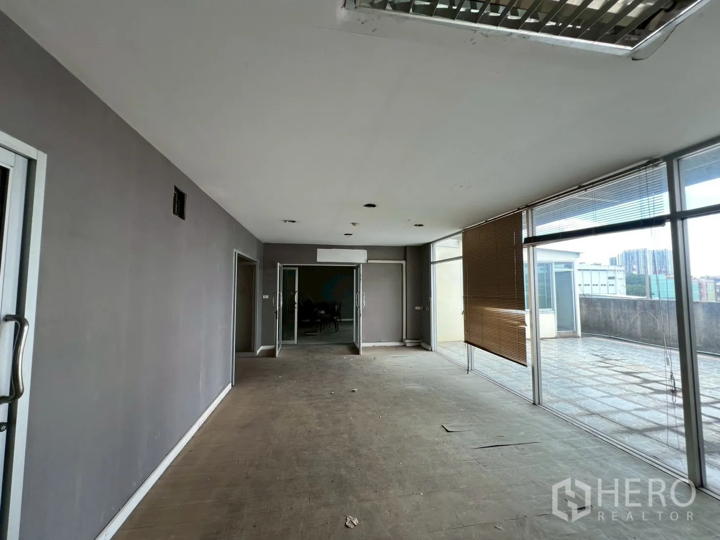 Shophouse for rent - Upper-floor room opening to rooftop terrace through full-height windows.