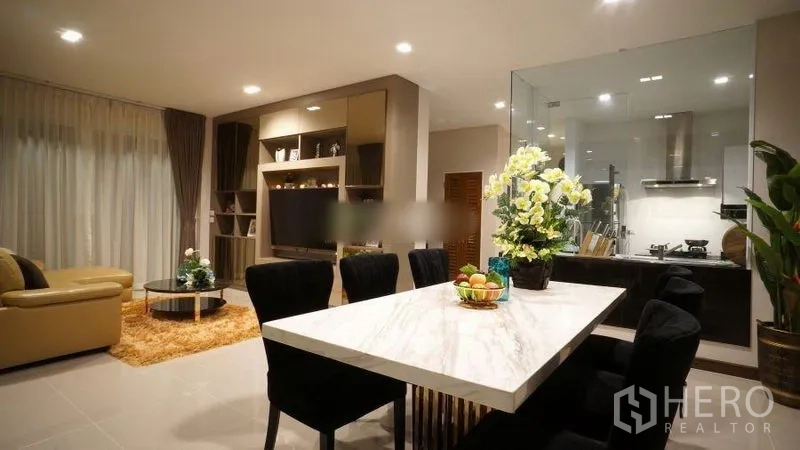 Detached House for rent or sale in Bang Phli, Samut Prakan - Dining area with marble-top table for six facing the living room and kitchen.