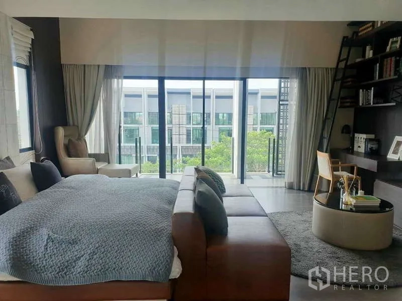 สำนักงานที่บ้าน ให้เช่าในBang Phli, Samut Prakan - ห้องนอนมาสเตอร์กว้าง โซฟา โต๊ะทำงาน ชั้นวางผนัง และประตูกระจกสไลด์ออกระเบียง