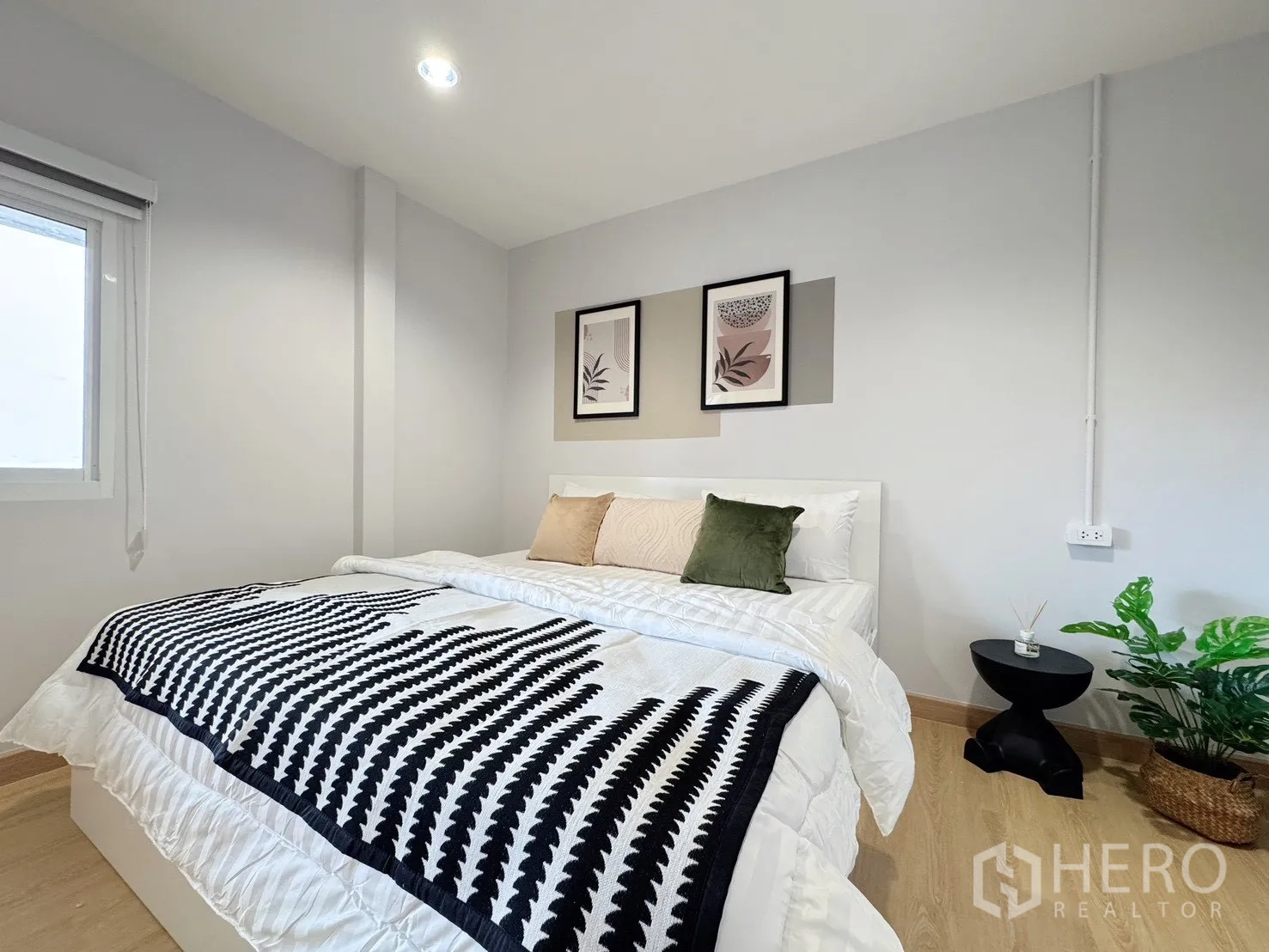 Detached House for rent - Bedroom with graphic throw, bedside table and indoor plant.