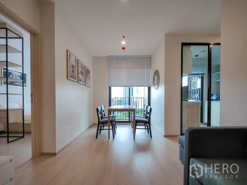 Condominium for rent - Dining nook by a floor-to-ceiling window with blinds, next to the enclosed kitchen.