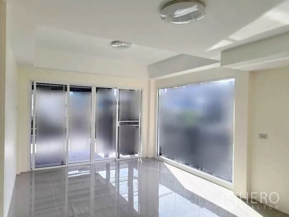 Home Office for rent in Bang Phli, Samut Prakan - Light-filled reception area with frosted glass sliding doors and a large window.