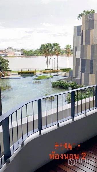 Condominium for rent in Yan Nawa, Bangkok - Bedroom balcony overlooking garden water features and the riverside promenade.