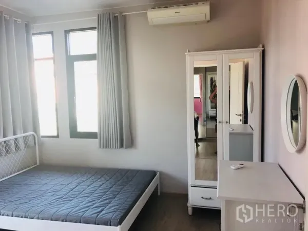 Detached House for rent in Bang Phli, Samut Prakan - Air-conditioned bedroom with bed frame, mirrored wardrobe and big windows with curtains