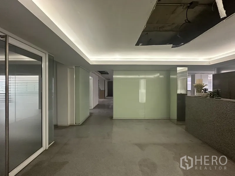 Office Space for rent in Khlong Toei, Bangkok - Lobby area with drop ceiling lighting, granite reception counter and glass partitions.