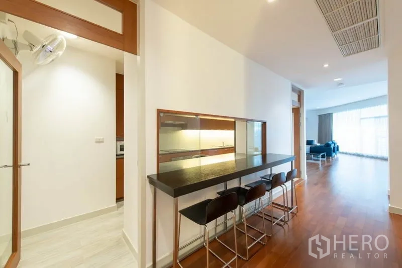 Condominium for rent - Hallway breakfast bar with stools and pass-through to kitchen, open to living area.