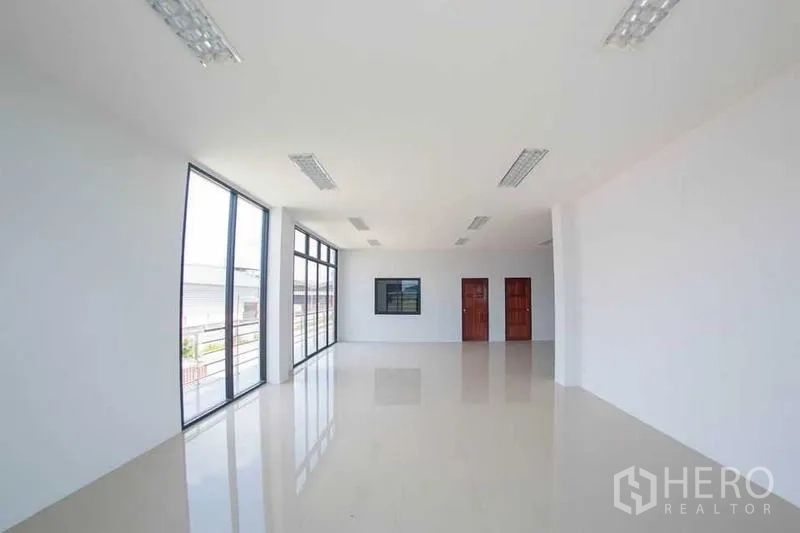 Warehouse for sale in Krathum Baen, Samut Sakhon - Open-plan office floor with full-height glass and double wooden doors.