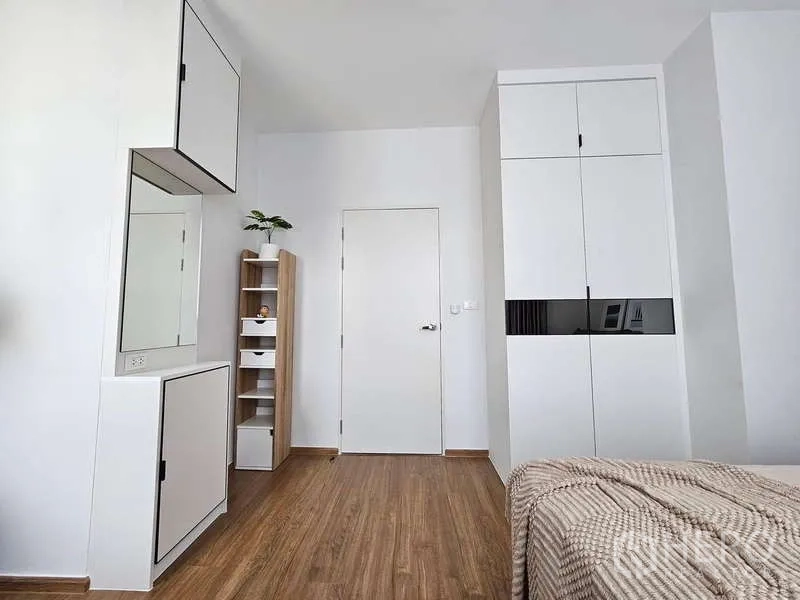 Townhouse for rent in Bang Phli, Samut Prakan - Bedroom view with wardrobes, minimalist storage and wood floors.