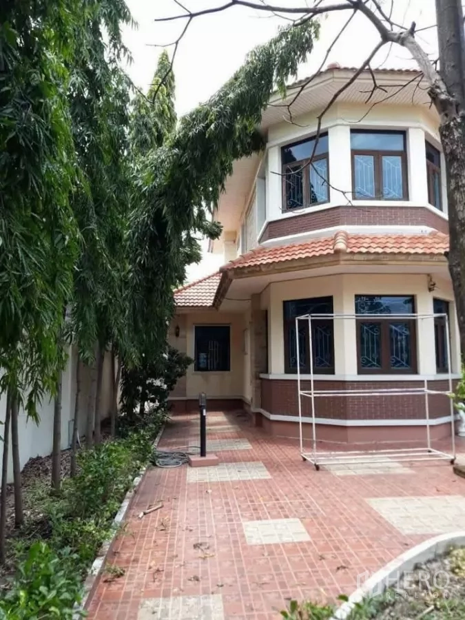 Detached House for sale in Bueng Kum, Bangkok - Side terrace and walkway beside the house with greenery.