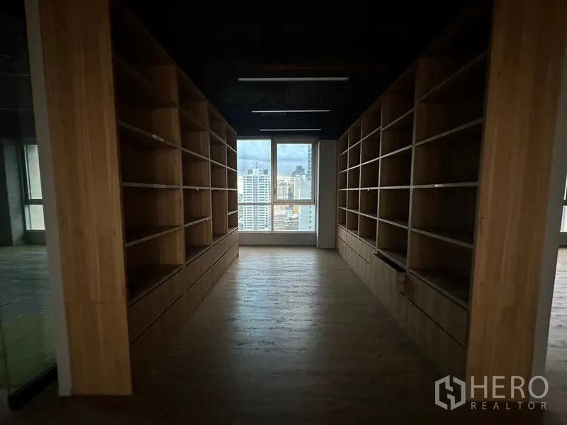 Office Space for rent in Bang Rak, Bangkok - Archive or storage room featuring twin rows of wooden shelving and a window.