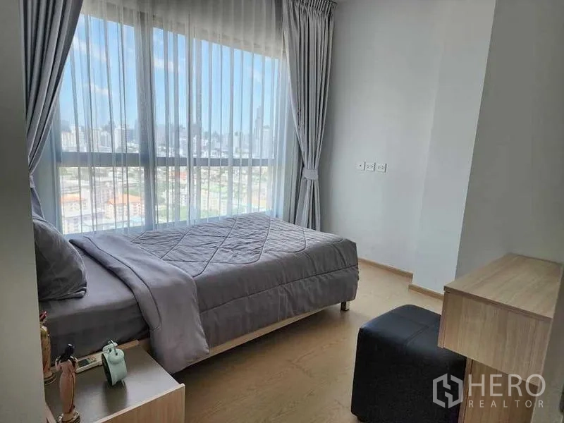 公寓 出租 - 次卧灰色床品，落地窗俯瞰城市景色。