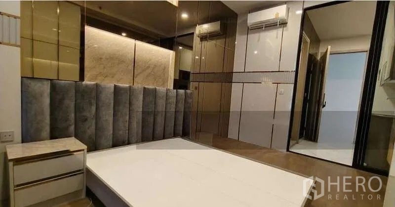 Condominium for sale - Cozy bedroom featuring a padded headboard, bedside tables, wardrobes and air conditioning.