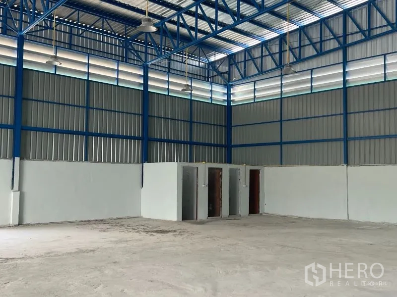 Warehouse for rent in Min Buri, Bangkok - Another interior angle emphasizing bright open space, window rows, and suspended lights.
