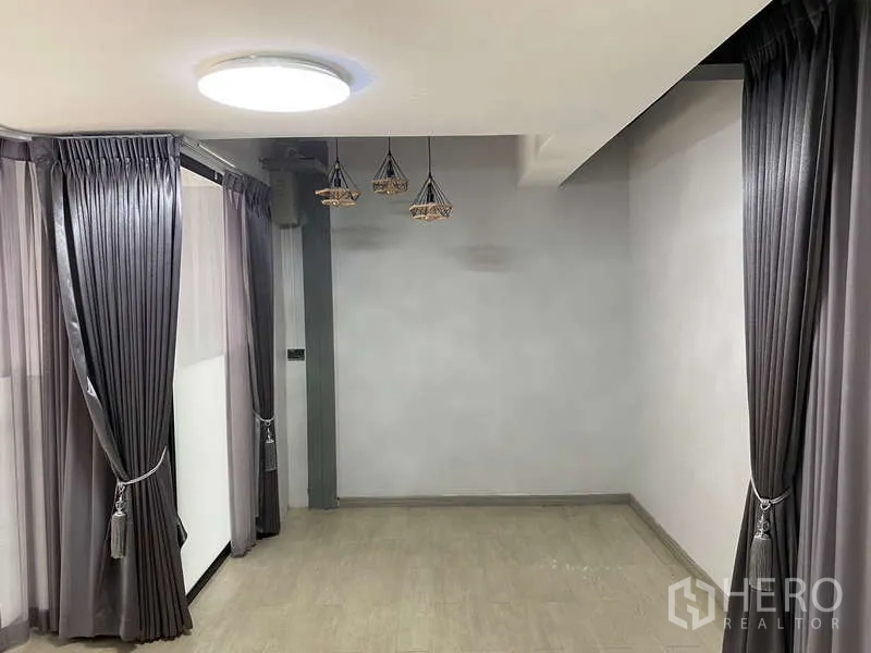 Home Office for rent or sale - Compact room with grey curtains on two sides and trio of geometric pendant lights.