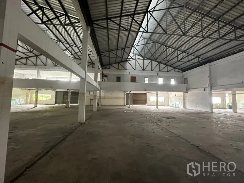 Factory for rent or sale in Khlong Luang, Pathum Thani - Factory hall with mezzanine offices and roller shutter loading bay.