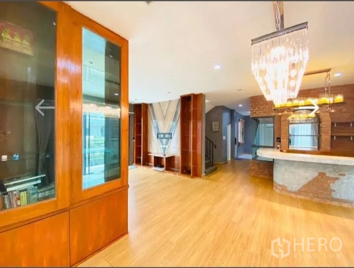 Detached House for sale in Saphan Sung, Bangkok - Living–dining space with built-in display cabinets and bar.