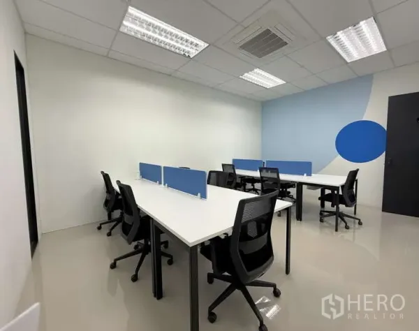 Office Space for rent in Huai Khwang, Bangkok - Bright serviced office with white desks, blue privacy panels, ergonomic chairs and ceiling lighting.