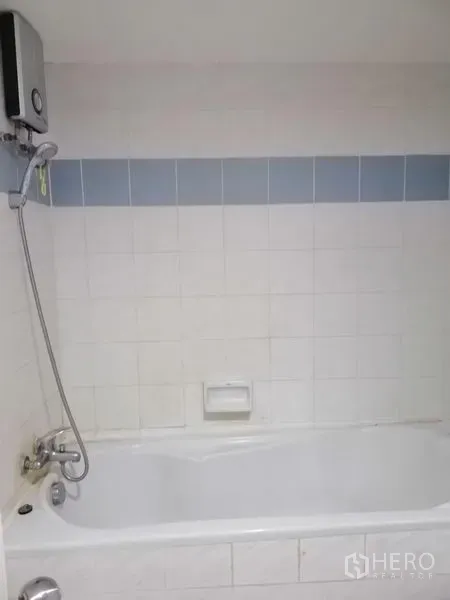Condominium for rent in Watthana, Bangkok - Bathroom featuring bathtub, handheld shower, and blue tile accent.
