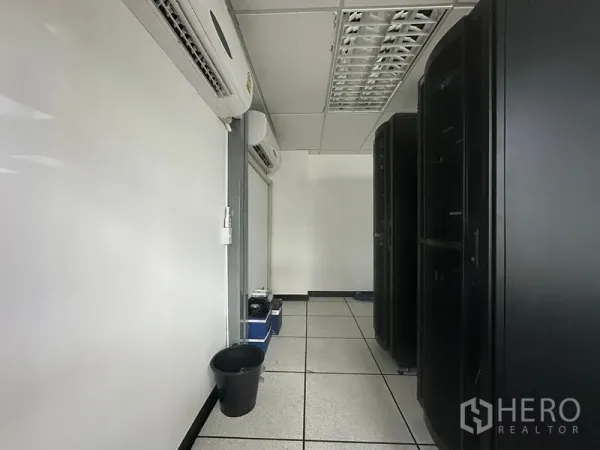 Office Space for rent - Dedicated server room with raised floor, multiple AC units and black rack cabinets in Bangkok office.