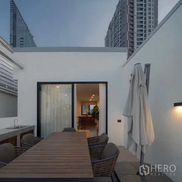 Detached House for rent in Bang Rak, Bangkok - Outdoor dining terrace with sink and sliding doors to the living room.