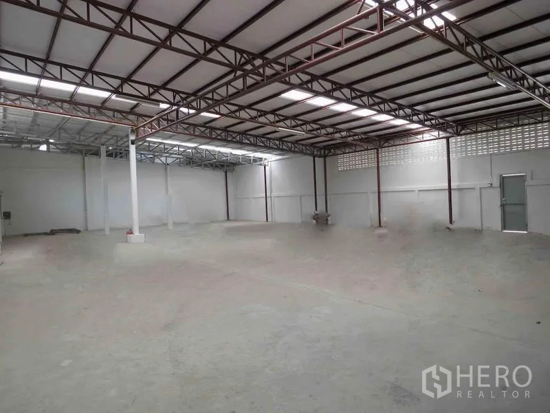 Warehouse for rent in Wang Thonglang, Bangkok - Large clear-span storage hall with steel truss roof, skylights and high ceiling.