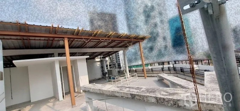 Shophouse for sale - Rooftop terrace with partial roof cover and utility area.