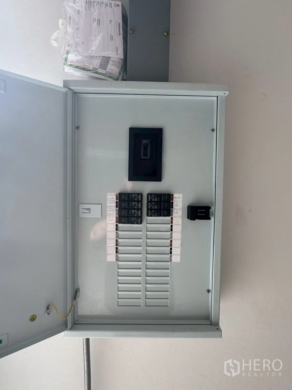 Warehouse for rent or sale in Nong Chok, Bangkok - Electrical distribution panel with labeled breakers installed inside the warehouse.