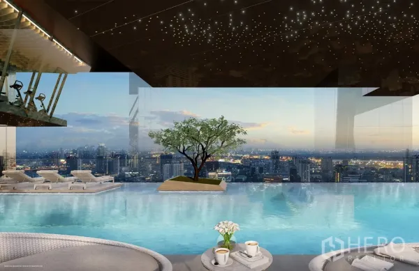 Condominium for sale in Watthana, Bangkok - Infinity‑edge swimming pool with sun loungers and wide skyline views at sunset.