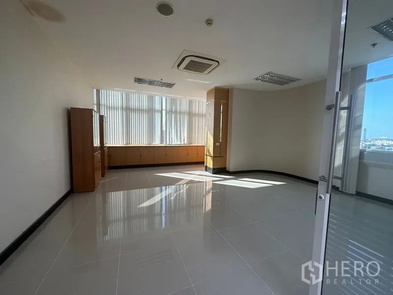 Office Space for rent in Suan Luang, Bangkok - Bright corner office with vertical blinds and built-in storage cabinets.
