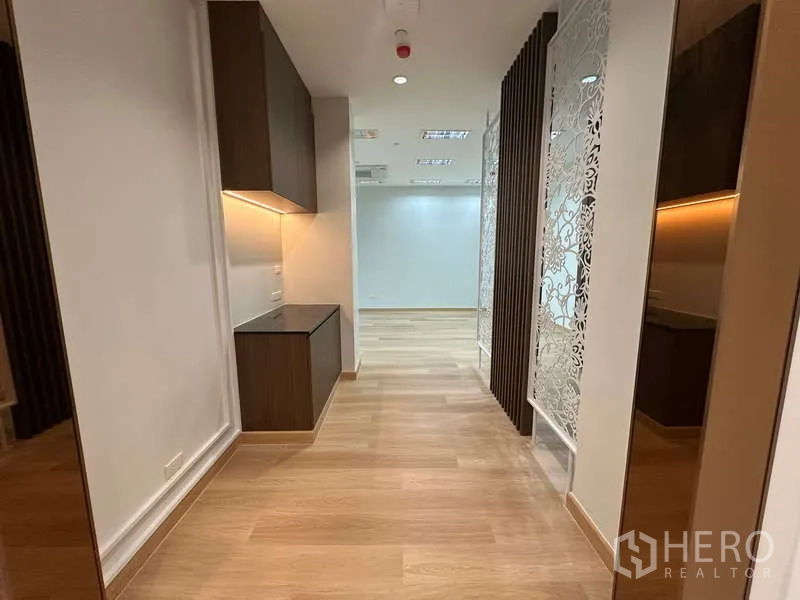 Office Space for rent - Hallway with built-in cabinetry, decorative screens and timber slat divider.