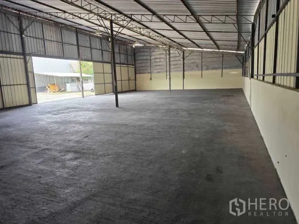 Warehouse for rent in Khlong Sam Wa, Bangkok - Open steel-frame warehouse interior with a high roof and concrete floor.