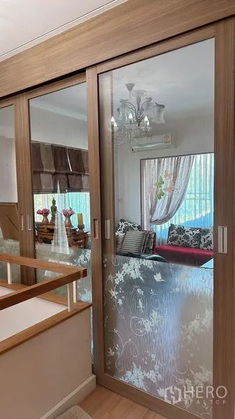 Detached House for rent in Bang Phli, Samut Prakan - Frosted glass sliding doors by the stairs opening to an upstairs sitting area with a chandelier.
