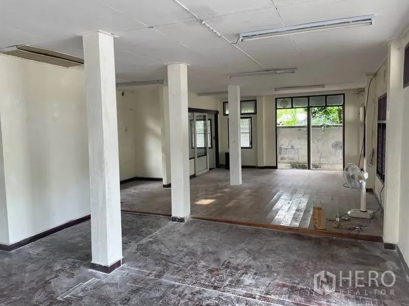 Detached House for rent in Suan Luang, Bangkok - Open ground floor with pillar supports and garden views through windows.