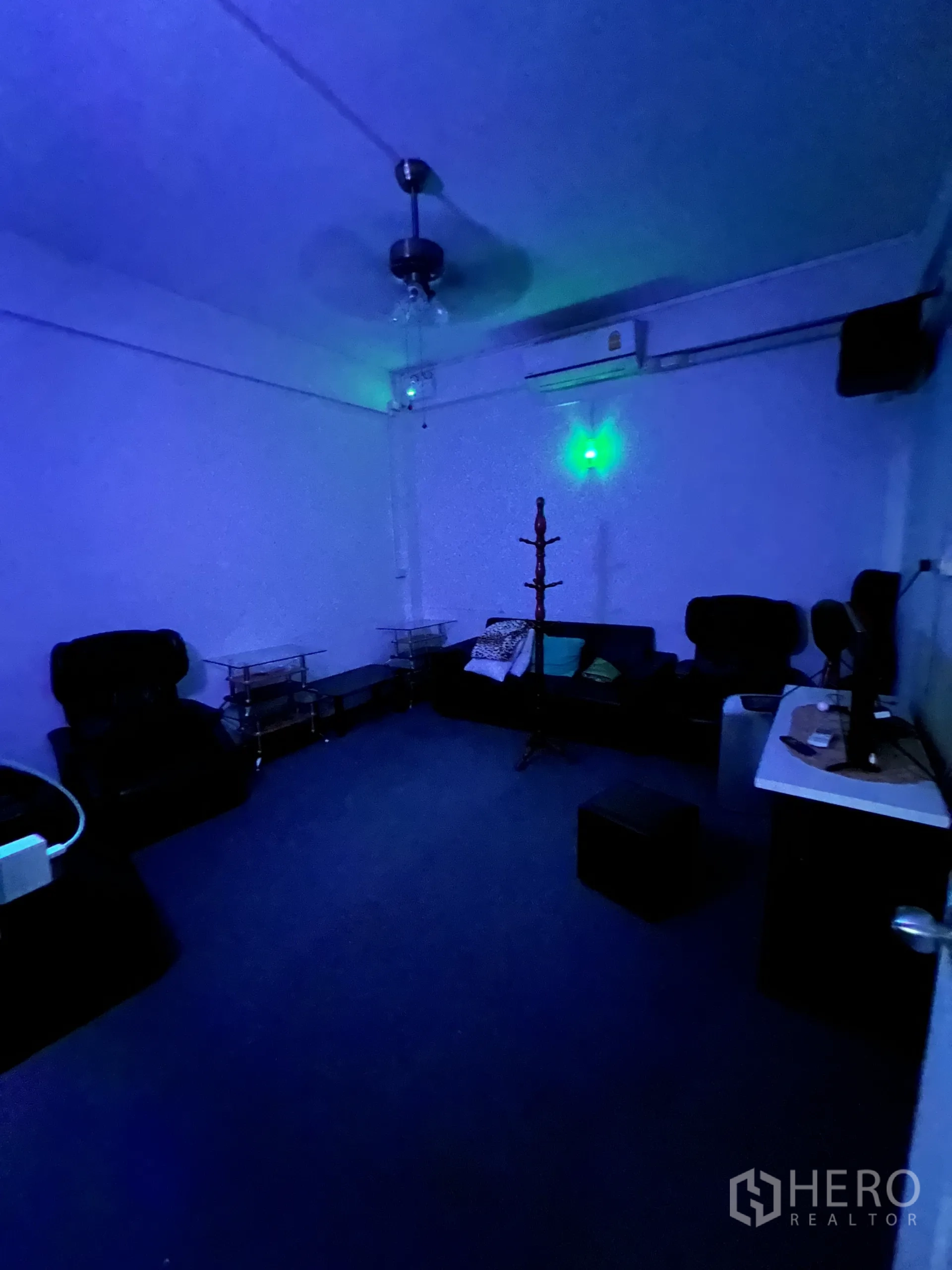 店屋 出租在Khlong Toei, Bangkok - 蓝色灯光的VIP休息室，沙发、吊扇与空调机。