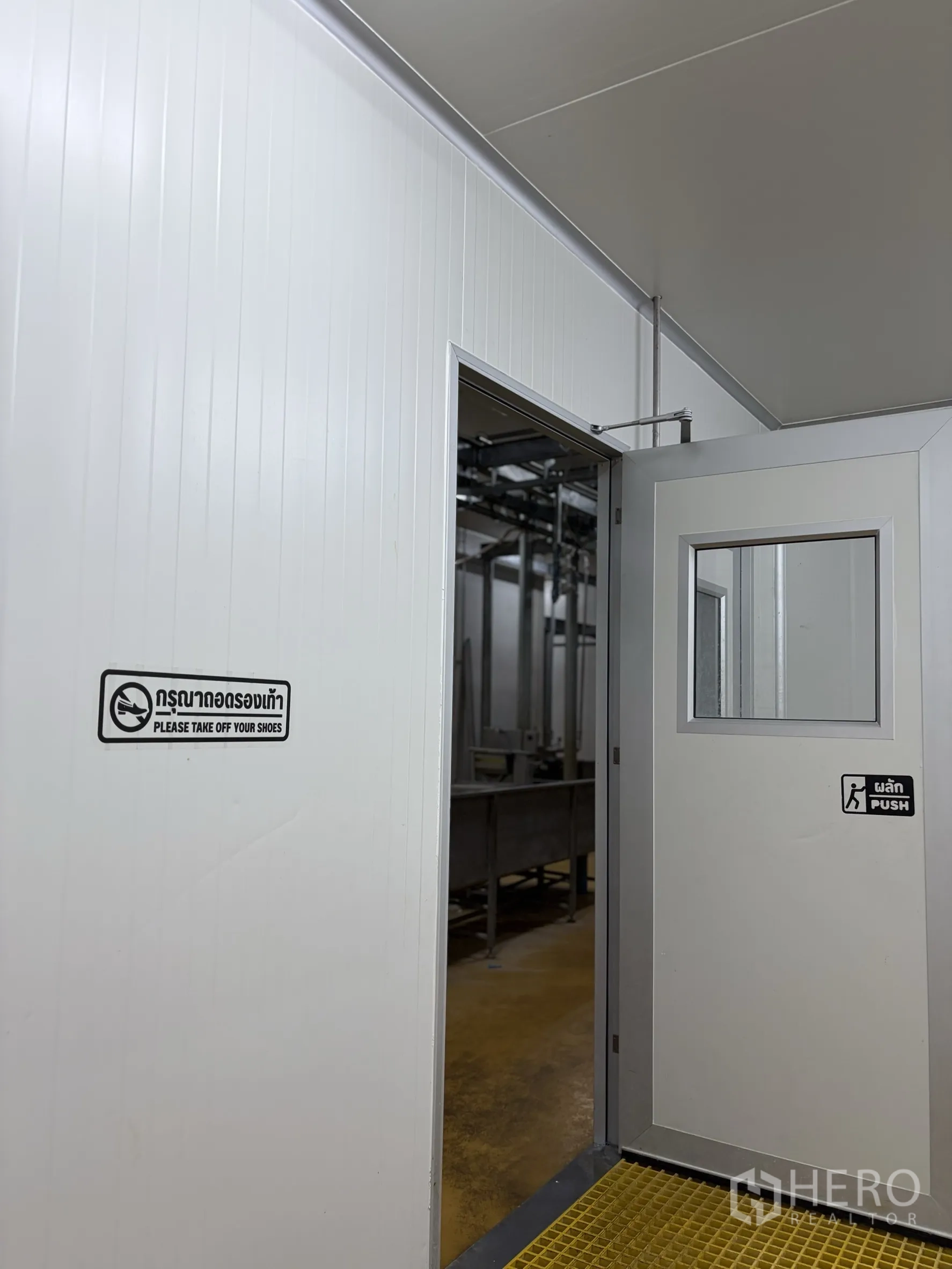 Factory for sale in Mueang Nakhon Pathom, Nakhon Pathom - Clean room entrance with insulated door, window, and hygiene signage.