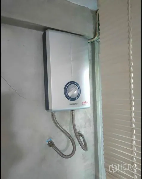 Detached House for rent in Wang Thonglang, Bangkok - Wall-mounted electric water heater on a cement wall.