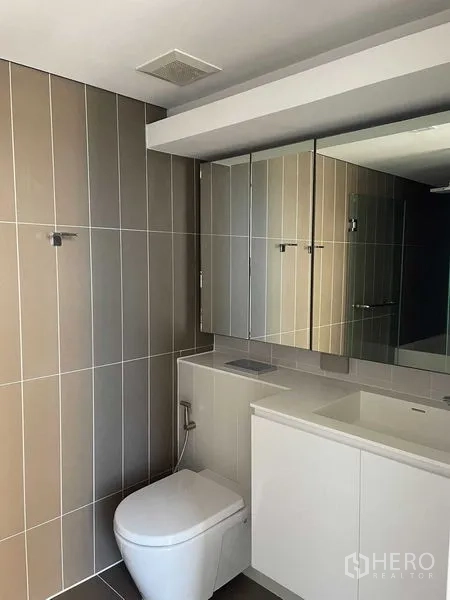 คอนโด ให้เช่าในKhlong Toei, Bangkok - ห้องน้ำที่สอง ผนังกระเบื้องยาว พร้อมโถสุขภัณฑ์และเคาน์เตอร์ล้างหน้า