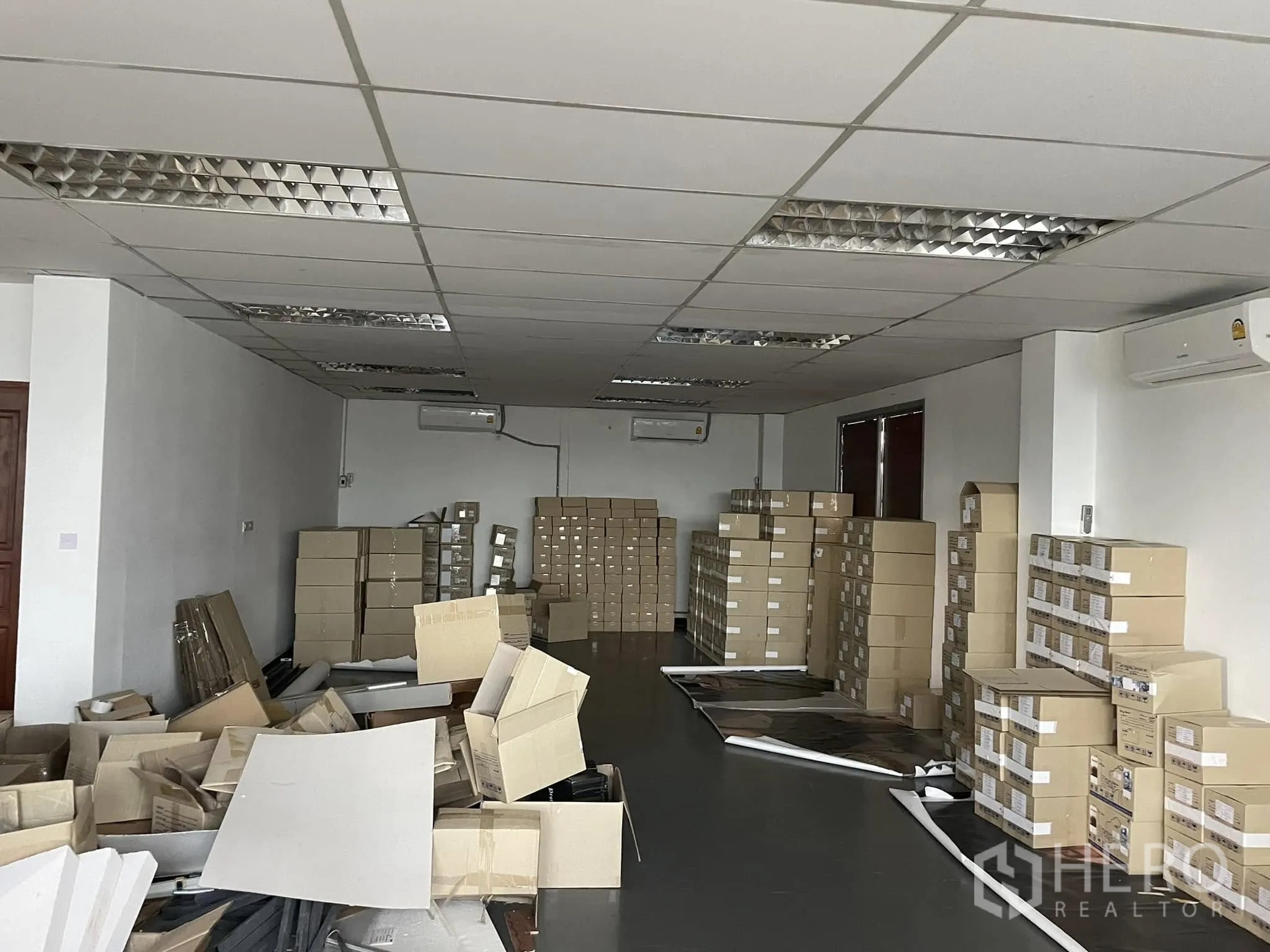 Office Space for rent in Lat Phrao, Bangkok - Large office area currently used for storage with stacked boxes.