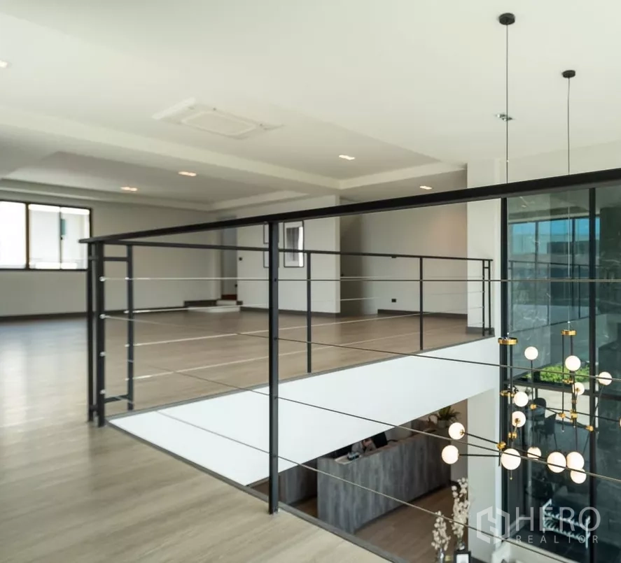 Home Office for sale in Bang Kapi, Bangkok - Mezzanine walkway overlooking a double-volume lobby with pendant lights.