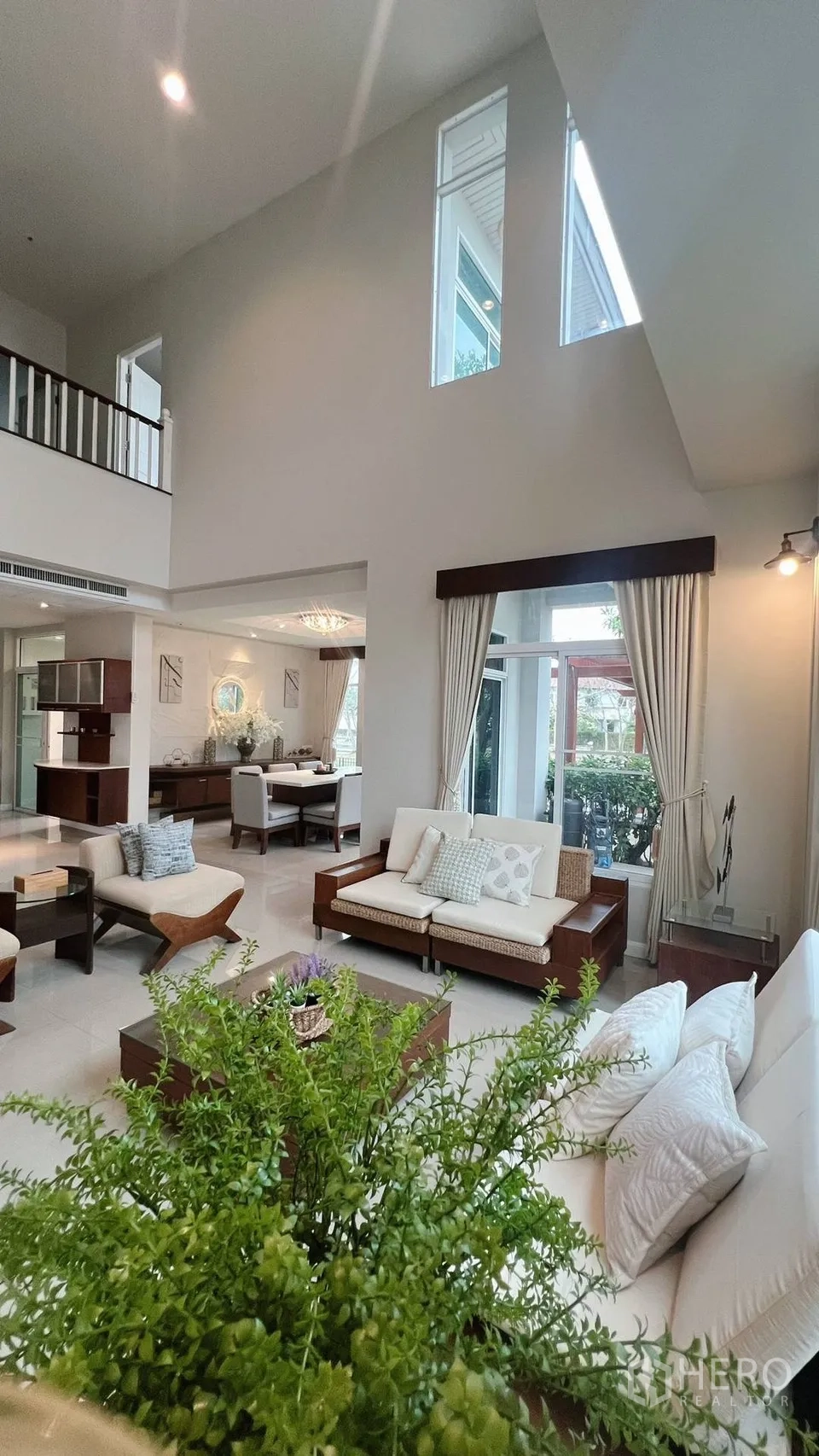 Detached House for rent in Lat Krabang, Bangkok - Living room outlook to kitchen and staircase with modern seating.