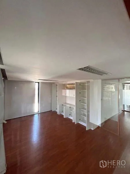Home Office for rent or sale in Bang Phli, Samut Prakan - Bright office with built-in shelves, air-conditioning and sliding glass partitions over wooden floors.