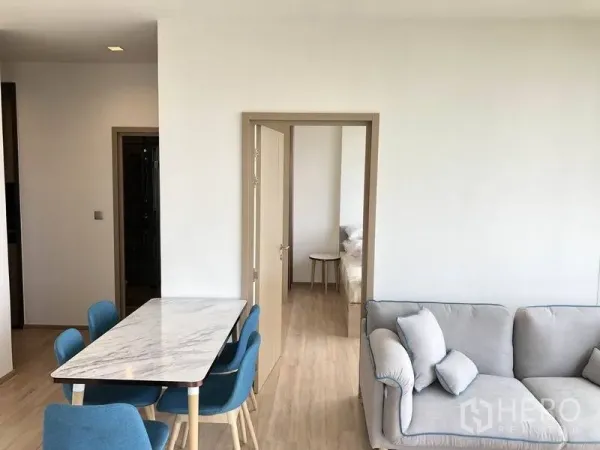 คอนโด ให้เช่าในWatthana, Bangkok - พื้นที่ทานอาหารแบบโอเพนแปลน โต๊ะท็อปหินอ่อน เก้าอี้สีน้ำเงิน เชื่อมสู่ประตูห้องนอน