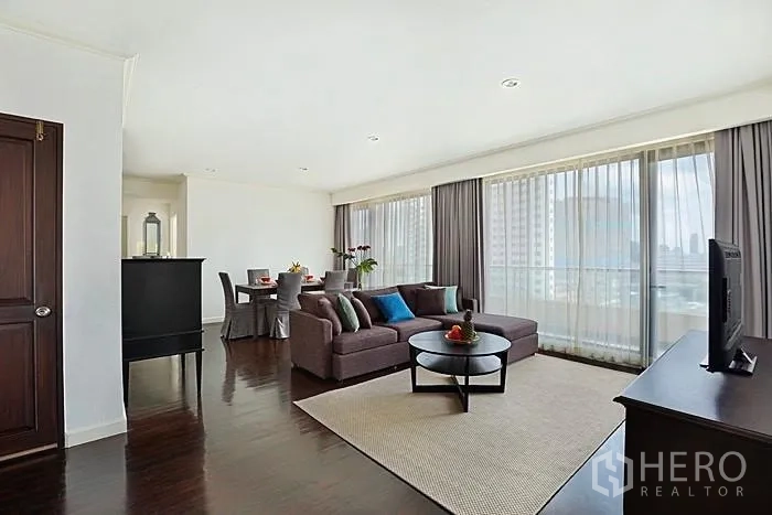 公寓 出租在Khlong San, Bangkok - 开放式客厅，转角沙发与落地窗连通阳台