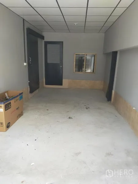 Detached House for rent in Watthana, Bangkok - Covered indoor garage or storage space with gray walls and paneled ceiling.