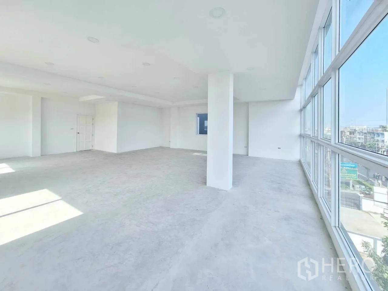 Office Space for sale in Bueng Kum, Bangkok - Open office level with windows on two sides and a doorway to stairs.