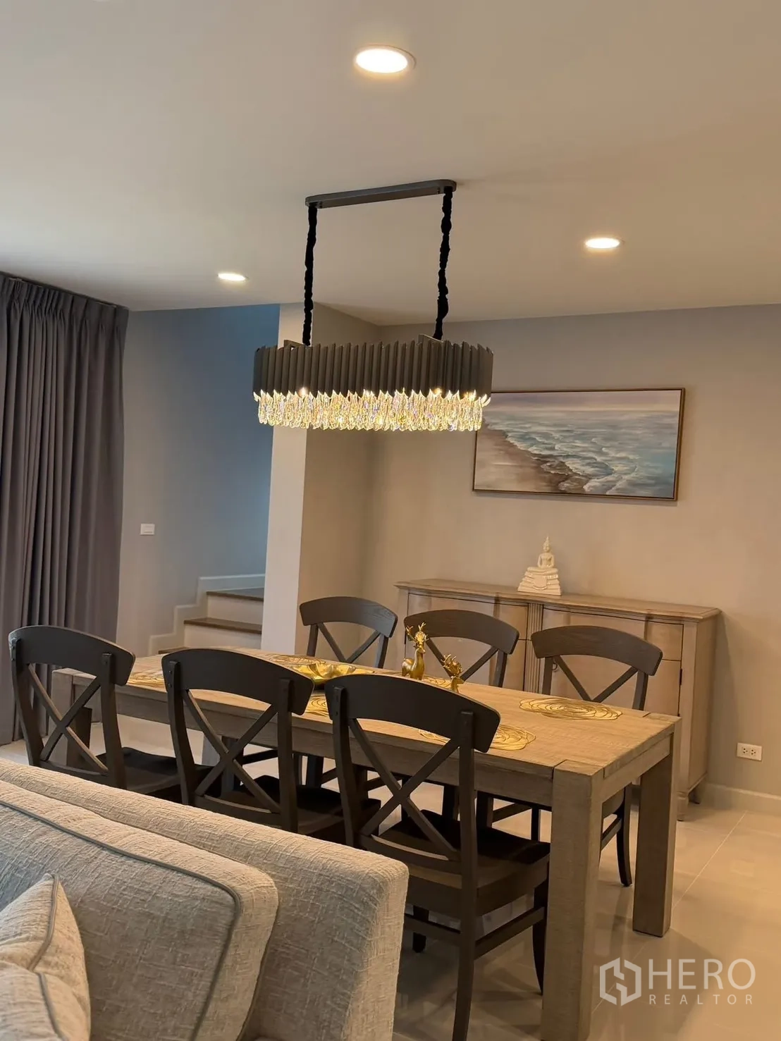 Detached House for rent in Bang Phli, Samut Prakan - Dining area next to a staircase and sideboard with feature lighting.