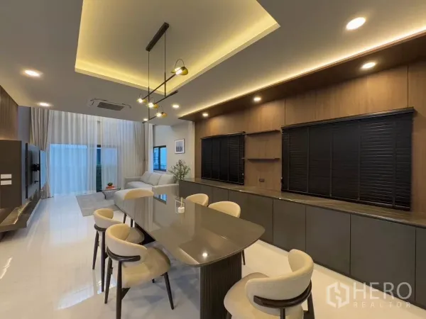 Detached House for rent in Bang Phli, Samut Prakan - Open-plan living and dining space with ambient ceiling lights and floor-to-ceiling drapes
