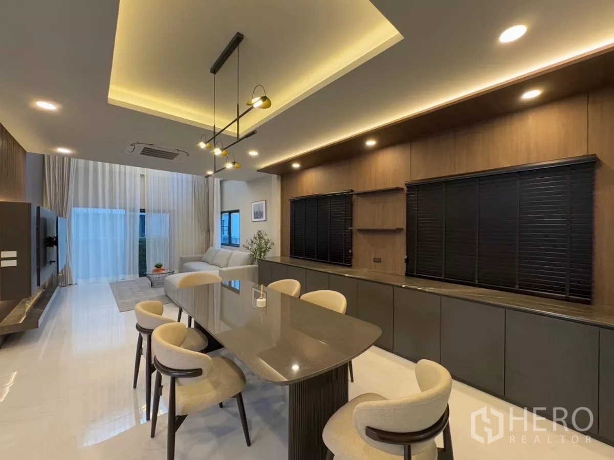 Detached House for rent in Bang Phli, Samut Prakan - Open-plan living and dining space with ambient ceiling lights and floor-to-ceiling drapes