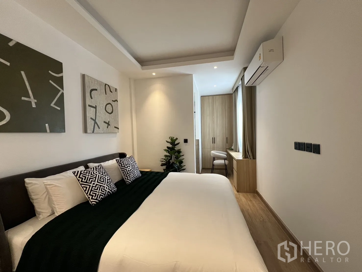 Townhouse for sale in Watthana, Bangkok - Bathroom with marble-look wall tiles, glass shower and vanity.