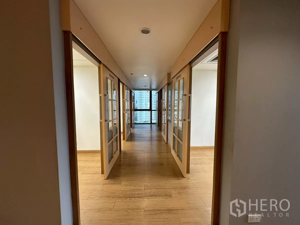 Office Space for rent in Khlong Toei, Bangkok - Central hallway with symmetrical glass doors leading to meeting rooms.